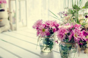 Pink and purple flowers near the window