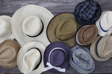 Straw hats fedoras on wooden floor
