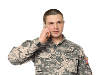 Soldier talking on mobile phone on white background
