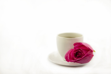 Fototapeta na wymiar cup of coffee with pink rose flower on a white background