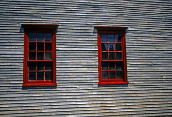Red windows on 19th century clapboard house