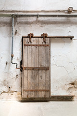  Grunge wooden roller door in prison cell.