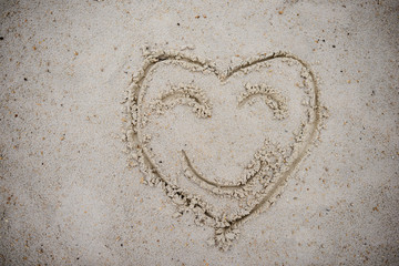 Heart, drawn on the beach sand. heart symbol on the sand washed