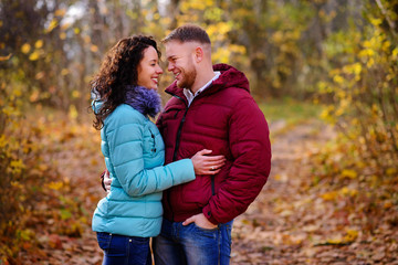 Fototapeta premium Lovers walking hand in hand in autumn park