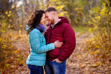 Fototapeta premium Lovers walking hand in hand in autumn park