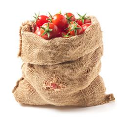 Tomatoes in canvas bag isolated on white background