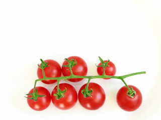 branch of fresh red cherry tomatoes isolated on the white