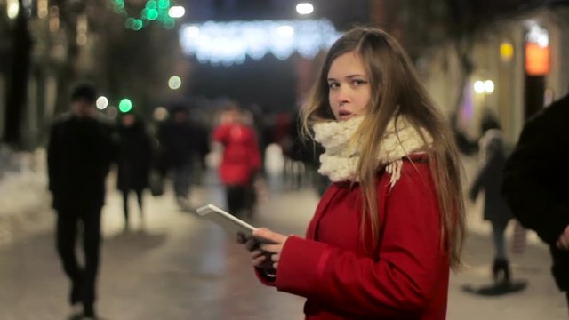 beautiful plump girl with tablet lost at street