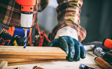 Worker holding an electric drill