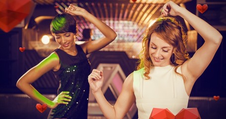 Composite image of smiling female friends dancing on dance floor
