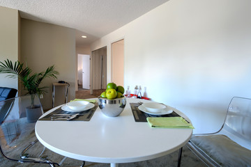 Bright dining room with a table set for dinner. Interior design.