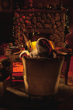 Santa Claus at Desk in Front of Fireplace