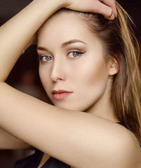 Naklejka premium Portrait of young pretty woman with perfect trendy nude makeup, gray eyes and long hair.