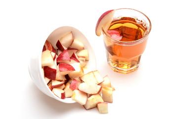 tea or juice with apple slice bowl isolated on white