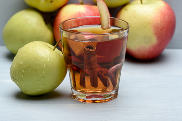 glass with juice, pieces of apple, cinnamon, apples