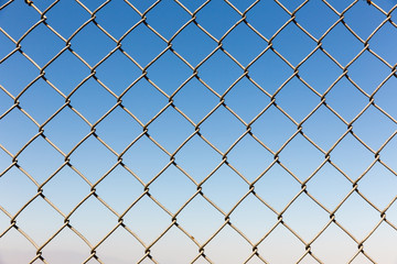 Fototapeta premium Fence rabitz closeup on blue sky background