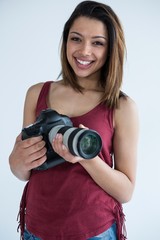 Fototapeta premium Happy female photographer standing in studio
