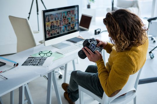 Male photographer reviewing captured photos