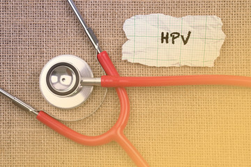 Stethoscope and paper with word hpv. Medical Concept