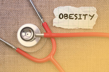 Stethoscope, paper with word “ OBESITY “. Medical Concept