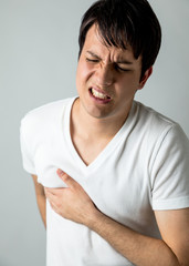 young man having a pain in his breast
