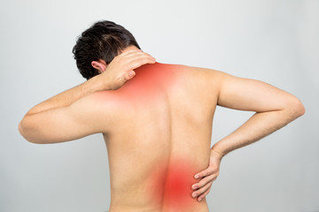 young man having a pain in his neck and back