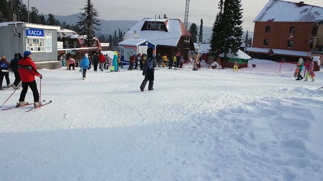 Skiers and snowboarders in the mountains at the ski resort 