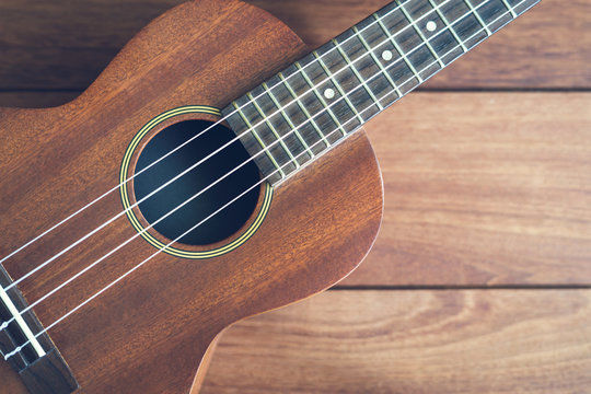 Ukulele guitar on wooden table