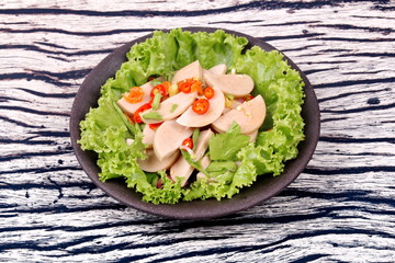 Spicy mixed vegetable salad with sliced Thai white pork sausage