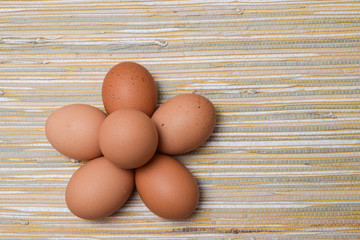 Chicken eggs in the straw tablecloth background
