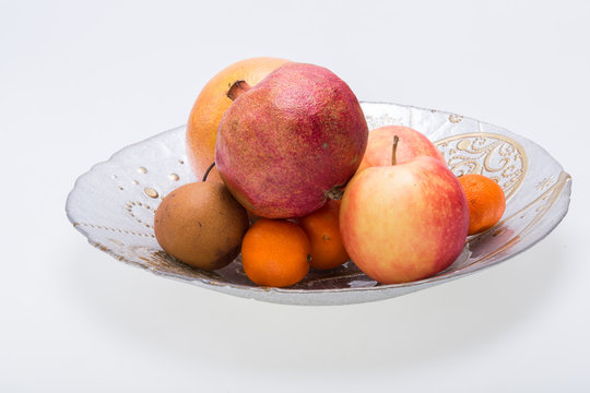 mix fresh fruits on plate isolated on white