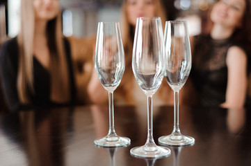 empty glasses of champagne on the background of the girls