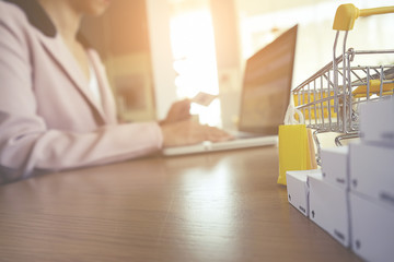 Internet online shopping concept with laptop and shopping-cart.Vintage tone retro filter effect, soft focus(selective focus)