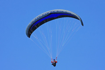 Paraglider in a blue sky