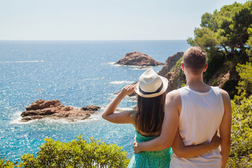 Young couple enjoying the view of the Costa Brava coast and the sea at the Tossa de Mar, Catalonia, Spain