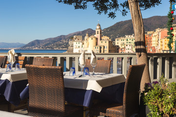 Table set in Italian restaurant in front of Camogli Bay, near Ge © ledmark31