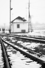 Old, rural railroads and railway station in winter time
