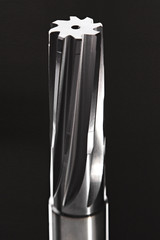 Metal reamer on black background. Professional cutting tools used for metalwork. Multiflute drill, broach bit, metal reamer, milling cutter