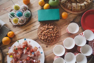 Poster Wooden table with different type of snacks preparing for party. © Make_story Studio