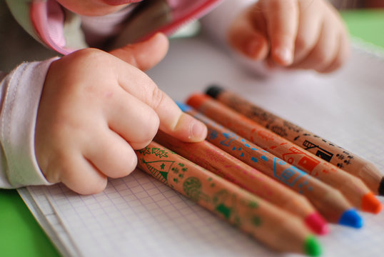 Child choosing a coloring pencil