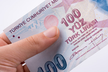 Hand holding 100 Turksh Lira banknotes  in hand