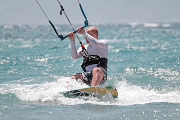 young blonde white man kitesurfing in bodrum, turkey