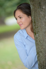 woman behind a tree