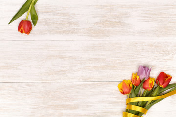 Lilac and red tulips in the white wooden table. Banner template layout mockup for Woman Day, Valentines Day and Teacher's Day. 