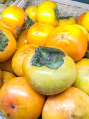Naklejka na ściany i meble Fresh Persimmon fruits in the market