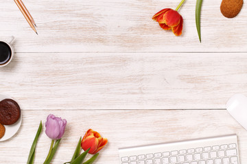 Lilac and red tulips in the white wooden table. View from above with copy space. Photo for posts, blogs, advertising and news