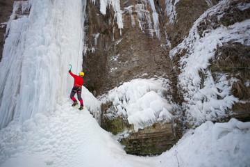 The climber climbs on ice.