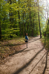 Obraz premium Young girl on a walk in the forest