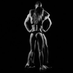 Fitness couple hugging, black and white