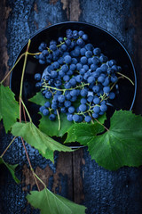 Blue grape on a wooden background
